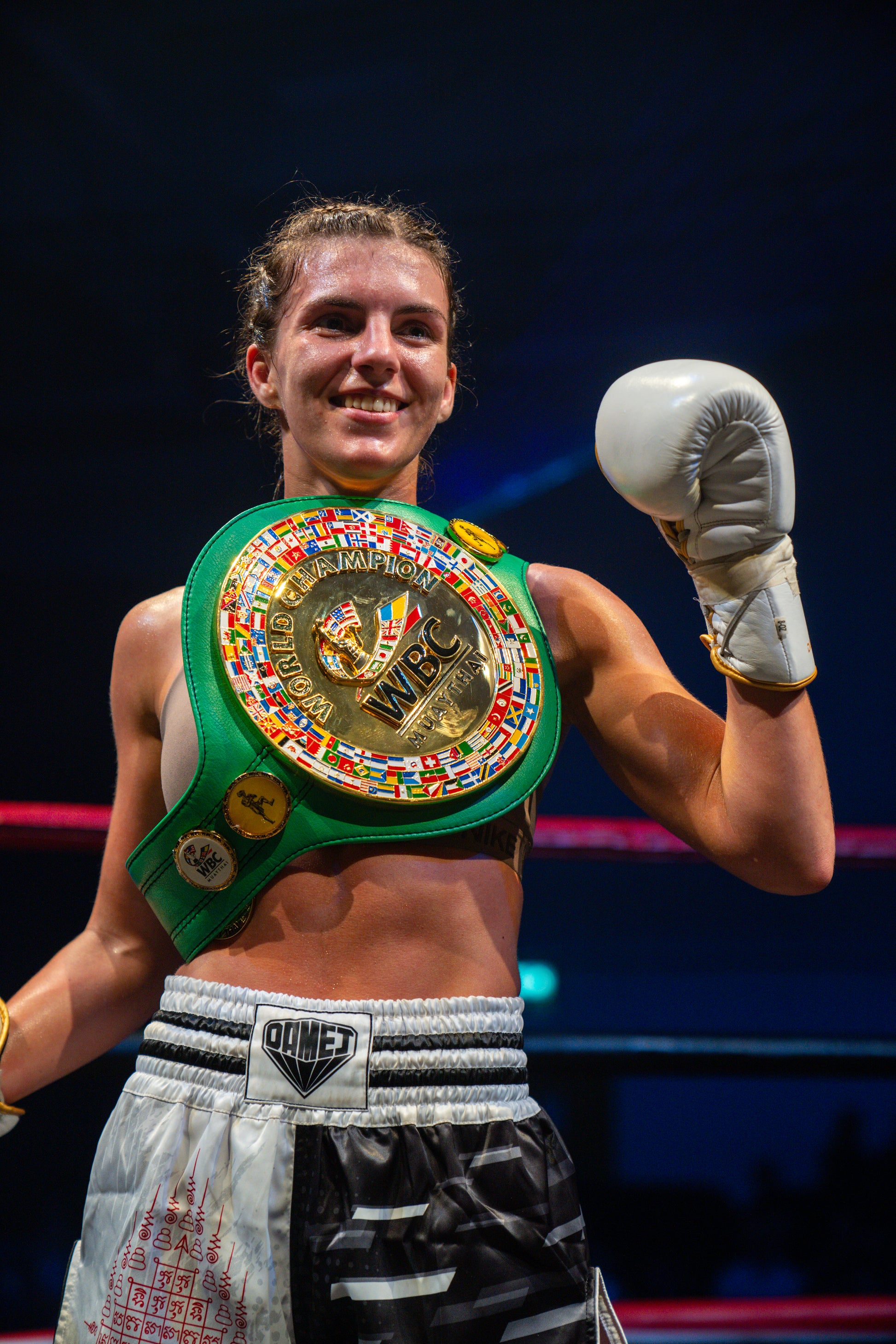 Jenna ross celebrates winning the WBC world title muay thai championship belt in a boxing ring